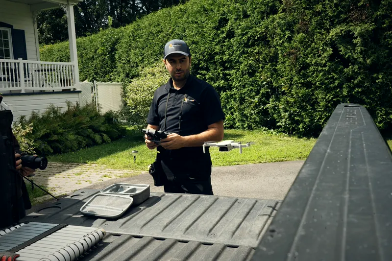 Inspector flying a drone from the bed of the truck.